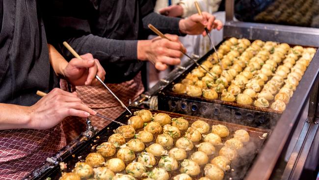 Cooking Takoyaki on hot pan in Osaka. Picture: Getty.