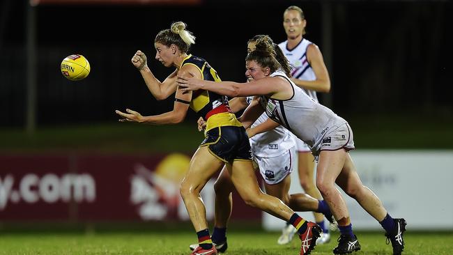 Adelaide Crow Deni Varnhagen passes the ball while being tackled by Fremantle Docker Cara Filocamo. Picture: Keri Megelus