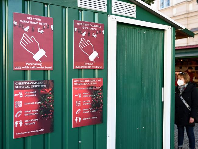 Signs for the 'Christmas Market Survival Guide' at a Christmas market in Salzburg, Austria, one day ahead of a nationwide lockdown to curb the pandemic. Picture: AFP