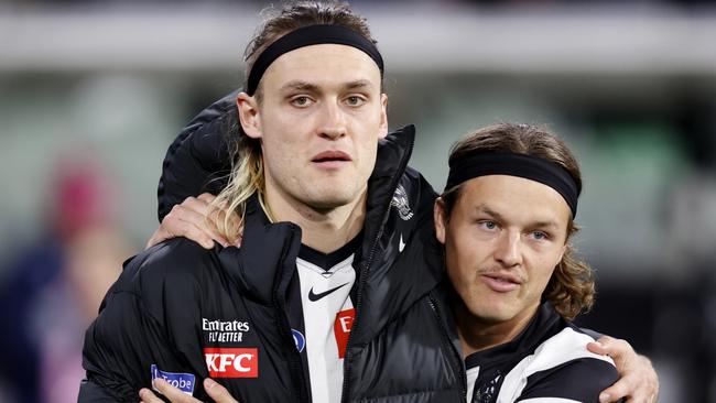 MELBOURNE, AUSTRALIA - AUGUST 11: Jack Ginnivan of the Magpies shares an embrace with Darcy Moore of the Magpies as Moore is subbed out of the game during the round 22 AFL match between Collingwood Magpies and Geelong Cats at Melbourne Cricket Ground, on August 11, 2023, in Melbourne, Australia. (Photo by Darrian Traynor/Getty Images)