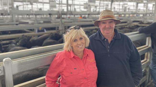 Marty and Lou Gleeson from Carrahil at Clarendon in front of their huge pen of 70 Angus steers which returned $2850 or 614c/kg.