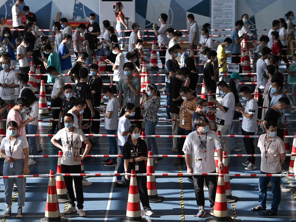 Staff queuing to test for the Covid-19 coronavirus at the gym of a company in Wuhan in China's central Hubei province On August 5. Picture: STR/AFP