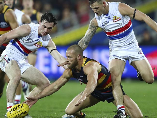 AFL - Adelaide Crows v Western Bulldogs at Adelaide Oval. Scott THompson trying to get the ground ball out with Toby McLean and Clay Smith giving pressure.  Picture Sarah Reed