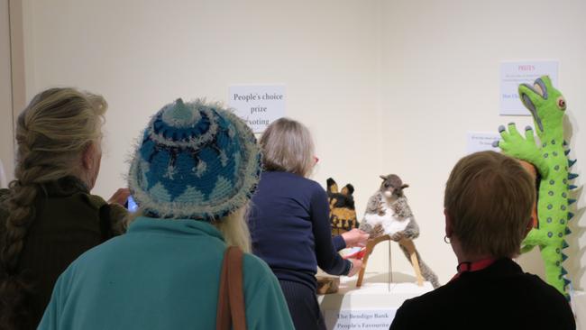 Onlookers crowd around this years people choice winning beanie, ‘ring tail possum’ by Lorraine Boomer. Picture: Gera Kazakov.