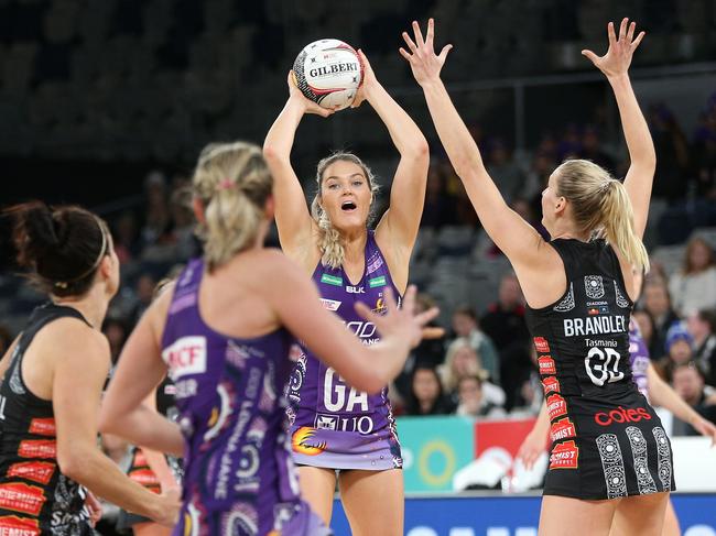 Gretel Tippett of the Firebirds passes under pressure from April Brandley of the Magpies (right) during the Round 9 Super Netball match between the Collingwood Magpies and the Queensland Firebirds at Melbourne Arena in Melbourne, Sunday, June 23, 2019.  (AAP Image/Hamish Blair) NO ARCHIVING, EDITORIAL USE ONLY