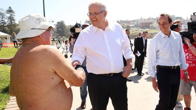 Scott Morrison greets a Bronte beach local during a walk with Wentworth candidate Dave Sharma yesterday. Picture: Sam Ruttyn