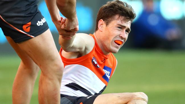Jeremy Cameron feels the strain as a teammate helps him to his feet against Fremantle. Picture: Getty Images