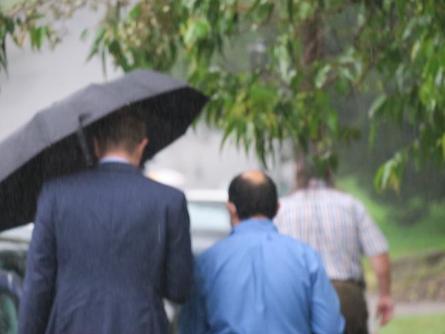 Doctor Fady Malak (blue shirt) leaving Gosford Local Court after an earlier appearance.