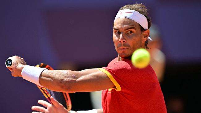 (FILES) Spain's Rafael Nadal eyes the ball as he returns to Serbia's Novak Djokovic during their men's singles second round tennis match on Court Philippe-Chatrier at the Roland-Garros Stadium at the Paris 2024 Olympic Games, in Paris on July 29, 2024. Rafael Nadal announced on October 10, 2024 he will retire from professional tennis after the Davis Cup finals in November, ending a career in which he won 22 Grand Slam titles and Olympic singles gold. (Photo by Martin  BERNETTI / AFP)