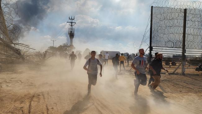 Palestinians take down the fence on the Israel-Gaza border. Picture: Getty Images