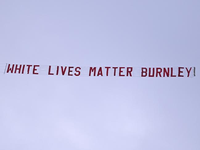 A plane towing a banner reading White Lives Matter Burnley flies above the stadium during the during the English Premier League soccer match between Manchester City and Burnley at Etihad Stadium, in Manchester, England, Monday, June 22, 2020. (AP Photo/Shaun Botterill,Pool)