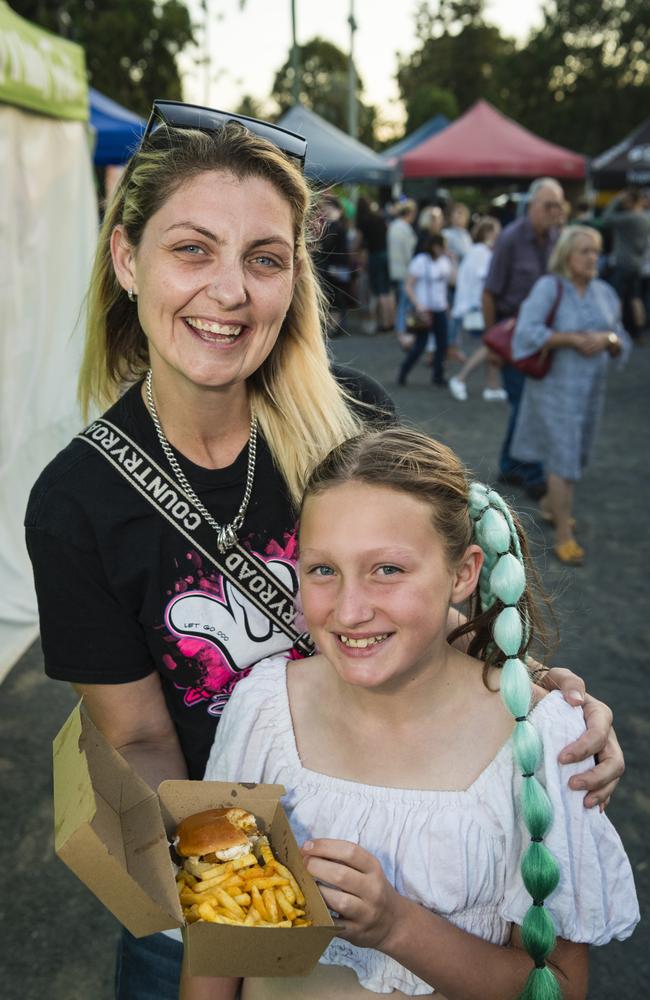 Jade Wright and niece Maddison-Lee Jackson with food from Flaming Knights at Twilight Eats at the Windmills, Saturday, November 18, 2023. Picture: Kevin Farmer