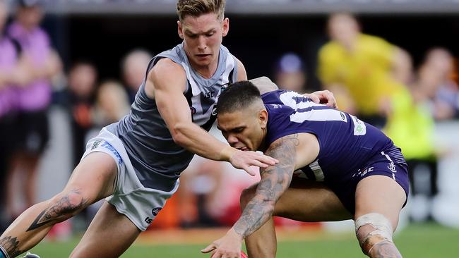 Port Adelaide’s Kane Farrell tackles Fremantle’s Michael Walters during the round 13 AFL match at Optus Stadium. Picture: Will Russell/AFL Photos/Getty Images.