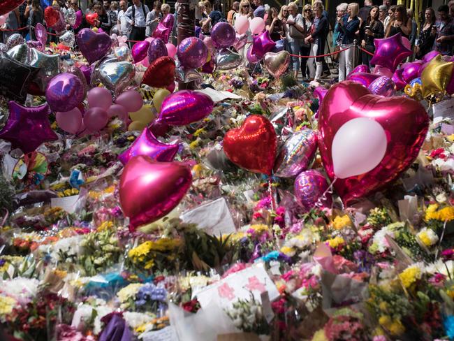 Flowers and balloons have been left outside St Ann's Square in Manchester after the deadly bombing that killed 22 people. Picture: AFP PHOTO / OLI SCARFF