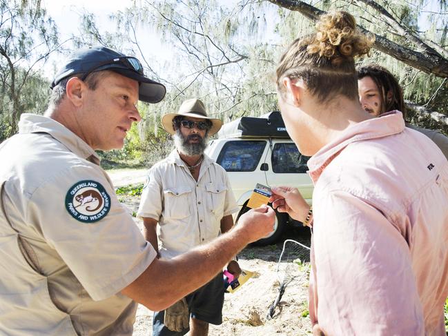 Rangers warning German backpackers about being dingo safe as they set up camp on Fraser Island. Photo Lachie Millard