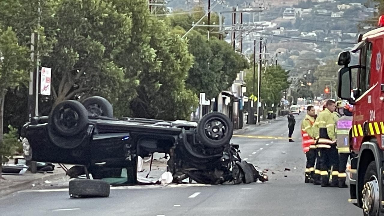 The black ute on its roof after hitting a Stobie pole on Glen Osmond Rd. Picture: Dylan Hogarth