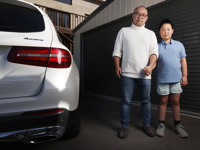 Jason Xu with son Ryan 11.  Jason Xu of Dynnyrne recently experienced people entering his property that captured on CCTV vision with items stolen.  Picture: Nikki Davis-Jones