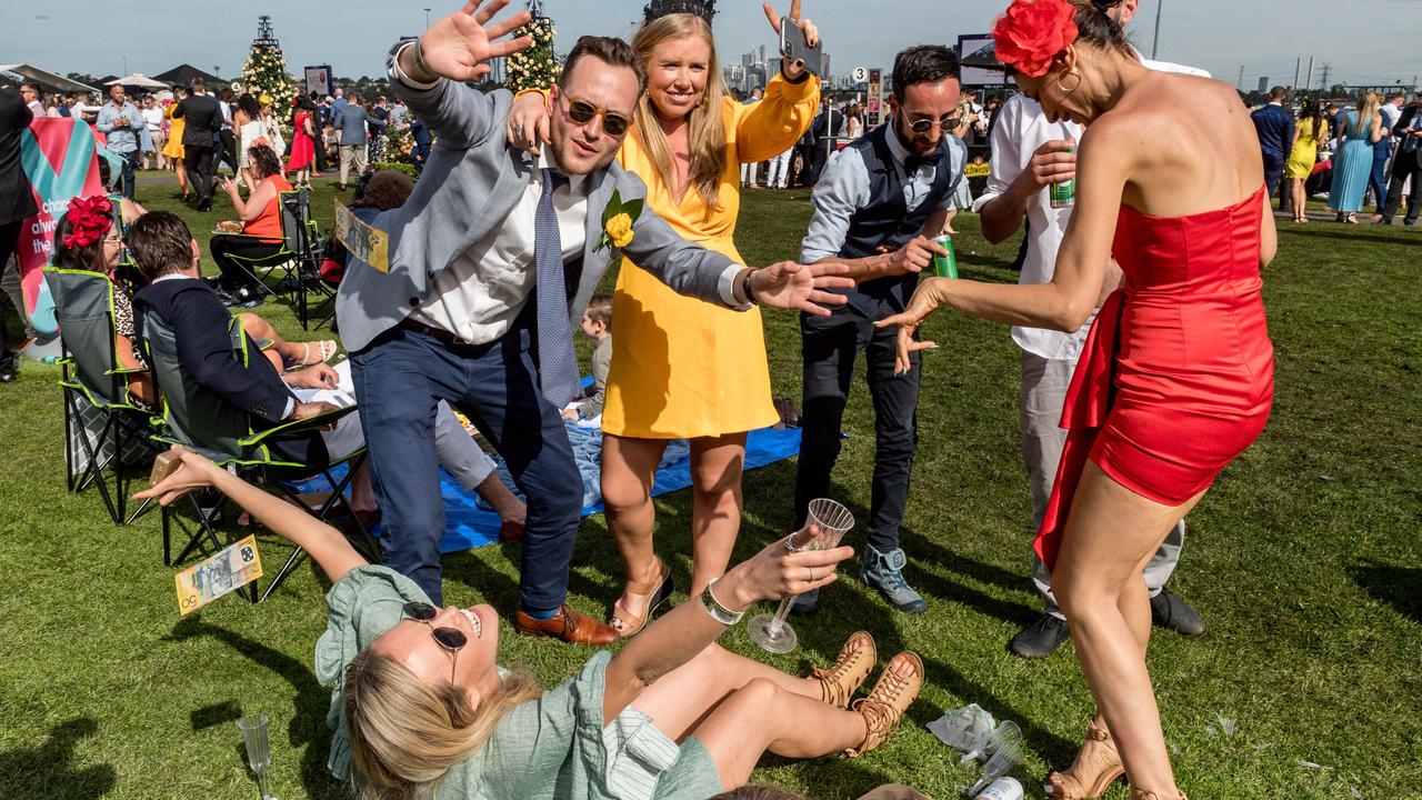 Thousands of punters braved bad weather at Flemington, but others struggled to find it on their TVs. Picture: Jake Nowakowski