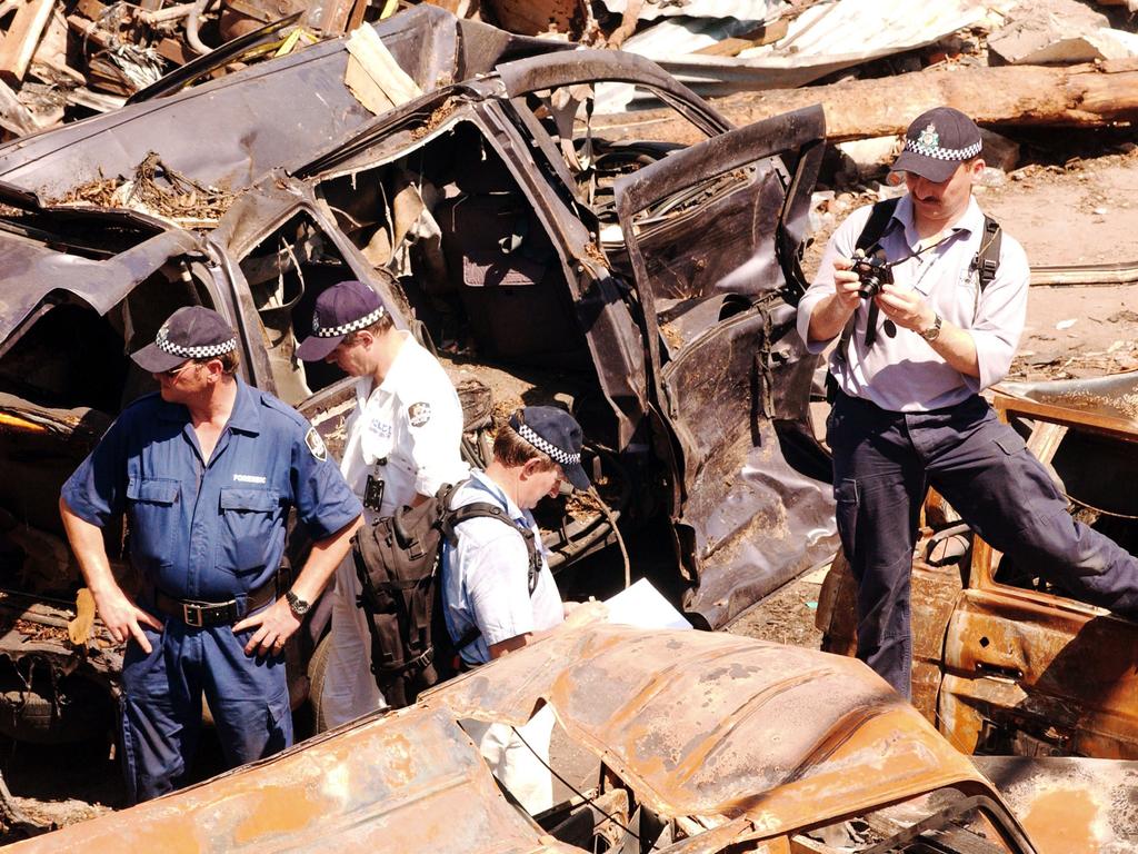 Australian Federal Police investigators walk through debris at the Bali nightclub bombing site on October 17, 2002 in Denpasar. Picture: Edy Purnomo/Getty Images