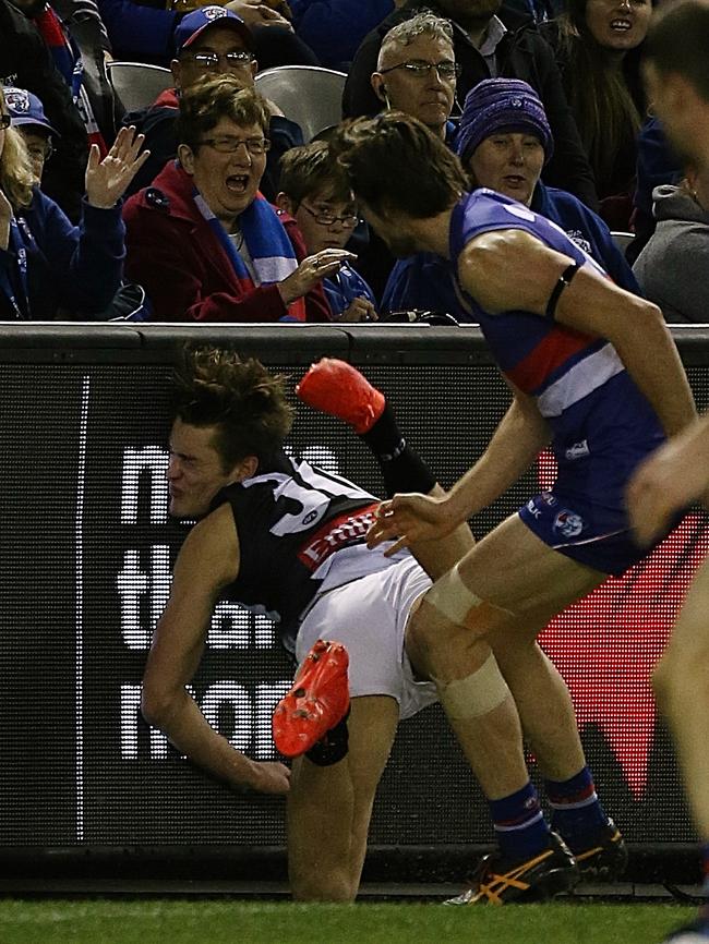 Darcy Moore crashes head first into the fence at Etihad Stadium. Picture: Wayne Ludbey