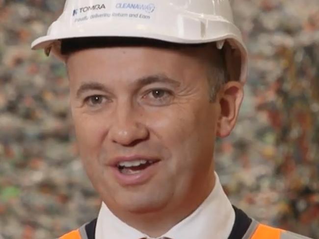 BIG EARNER: Environment minister Matt Kean talks up the return and earn scheme in front of mountains of recyclable plastic.