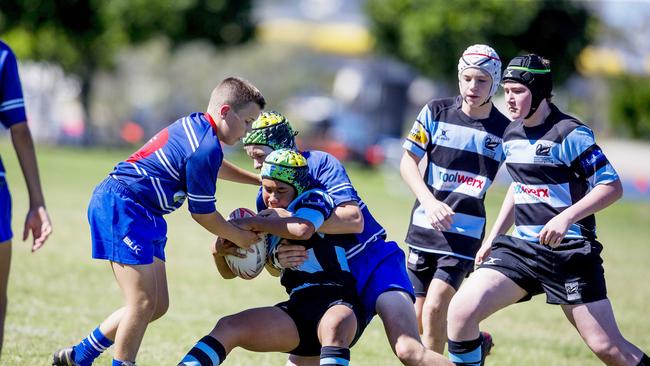Day One of King of the Country rugby tournament at James Overell Park, Southport. Maroochydore Swans U14s' Andy Bailey in action against USQ Saints U14s (blue white small stripes). Picture: Jerad Williams