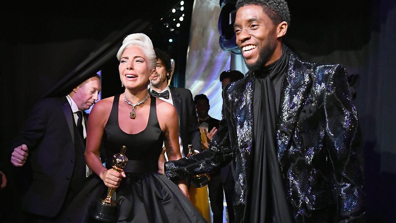 Lady Gaga poses with the Music (Original Song) award for Shallow from Star Is Born backstage with presenter Chadwick Boseman. Picture: Getty Images