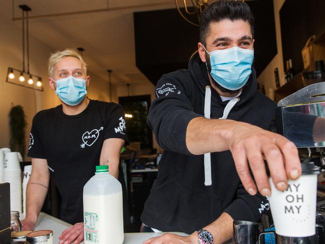 Adam Zeineddine (R), owner of Swan Street cafe My Oh My and barista Andy Balloch adopted the use of masks early. The Victorian Government announced today that face coverings in public will be mandatory From Wednesday night in the Greater Melbourne and Mitchell Shire.Photograph by Paul JeffersThe Australian19 July 2020