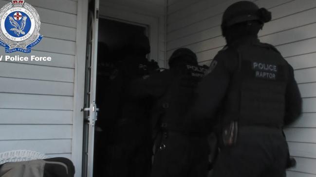 Armed police enter a house at Beverly Hills. Picture: NSW Police