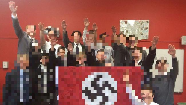 Year 12 students posing with a Nazi flag