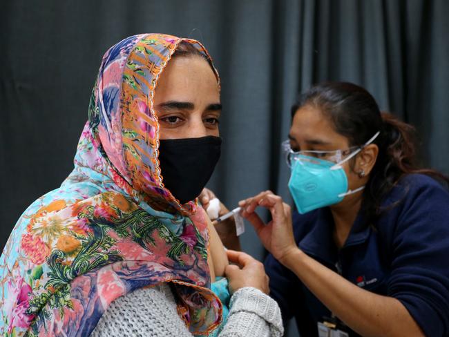 SYDNEY, AUSTRALIA - AUGUST 26: Registered Nurse Shalini administers a Pfizer COVID-19 vaccine to a person visiting the Australian Sikh Association (ASA) pop-up clinic on August 26, 2021 in Sydney, Australia. The Australian Sikh Association has been active in the community encouraging people to get vaccinated for COVID-19, hosting a vaccination pop-up clinic at the Gurdwara Sahib in Glenwood for locals to receive the coronavirus vaccine. The Australian Sikh Association (ASA) serves Sydney's Gurdwara Sahib Glenwood - the largest Sikh congregation in Australia. The Gurdwara Sahib at Glenwood is the hub of religious and community activities all year round where members of the Sikh community visit the Gurdwara Sahib to pray, meditate and listen to the teachings and hymns from Shri Guru Granth Sahib. (Photo by Lisa Maree Williams/Getty Images)