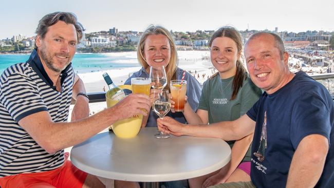 Dave Farquharson, Liz Farquharson, Lucy Garvey and Ben Garvey enjoy a drink in the sun at North Bondi RSL. Picture: Thomas Lisson