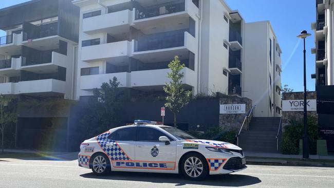 A police car passes the 12 High Street unit complex which has been caught up in a Covid-19 scare.