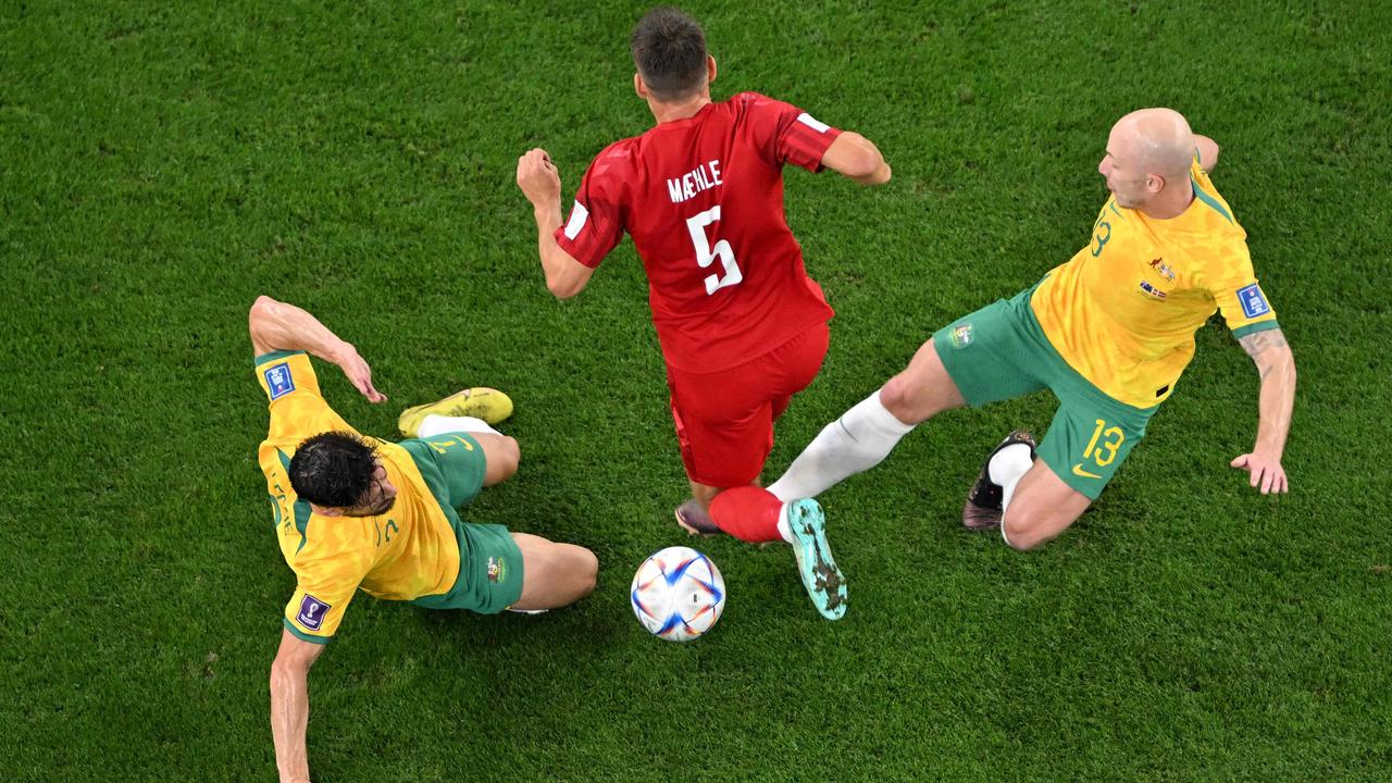 Joakim Maehle fights for the ball with Australia's Mathew Leckie and Aaron Mooy. Photo by FranÃ§ois-Xavier MARIT / AFP.