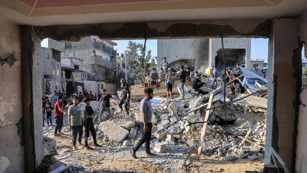 People gather by the rubble of a building in the aftermath of an Israeli air strike in Rafah in the southern Gaza Strip. Picture: AFP