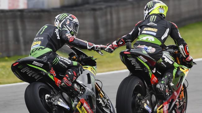 Johann Zarco, right, celebrates with teammate Jonas Folger after winning the MotoGP qualifying session.