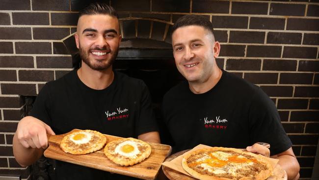 Jeremy Agha and Yum Yum Bakery owner Najib Haddad with their top pizza. Picture: Robert Pozo