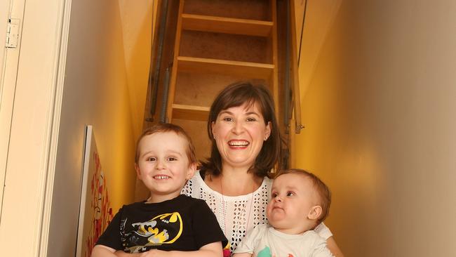 Ari Mottek stands below her attic with children Reuben, 4, and Felix, 1. Picture Chris Pavlich.