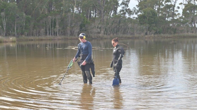 Armed with metal detectors, officers searched the shallow water for any clues.