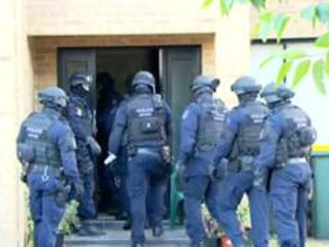 Heavily armed police carrying out raids in Sydney's south west. Pic: 9NEWS.