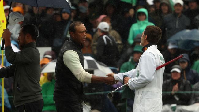 AUGUSTA, GEORGIA - APRIL 08: Tiger Woods of the United States shakes hands with Viktor Hovland of Norway caddie Shay Knight on the 18th green during the continuation of the weather delayed second round of the 2023 Masters Tournament at Augusta National Golf Club on April 08, 2023 in Augusta, Georgia. (Photo by Patrick Smith/Getty Images)