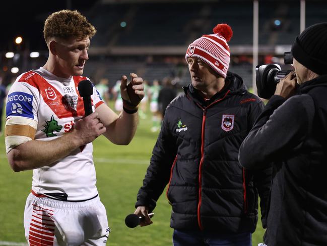 WOLLONGONG, AUSTRALIA - JULY 07:  Dan Russell of the Dragons is interviewed by a Dragons club personnel after the round 19 NRL match between St George Illawarra Dragons and Canberra Raiders at WIN Stadium on July 07, 2023 in Wollongong, Australia. (Photo by Matt King/Getty Images)