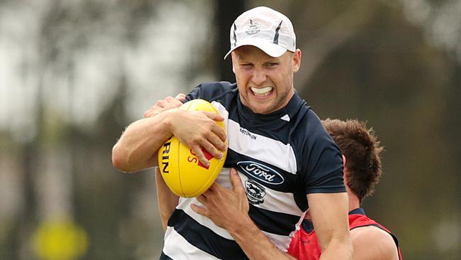 Returning star Gary Ablett smashes past Dan Menzel at Cats training. Picture: Alison Wynd