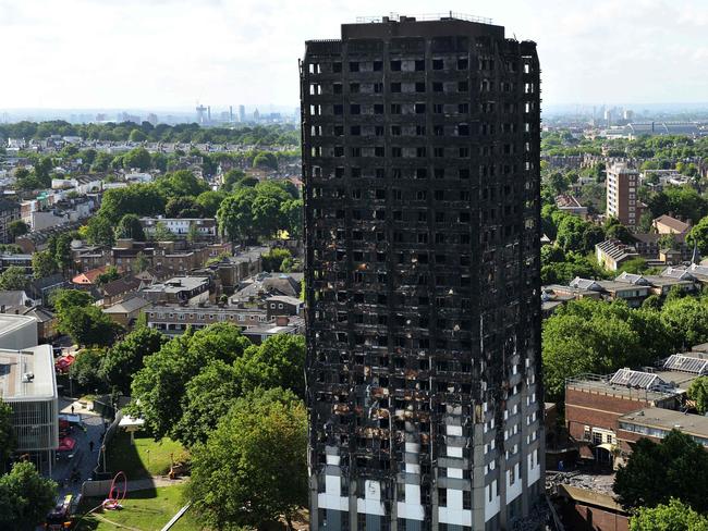 (FILES) In this file photo taken on June 16, 2017 the remains of Grenfell Tower, a residential tower block in west London which was gutted by fire, are pictured against the London skyline. - The London Fire Brigade has been condemned for "serious shortcomings" and systemic failures in its response to the Grenfell Tower fire, in a report after the first phase of an inquiry on October 29, 2019. (Photo by CHRIS J RATCLIFFE / AFP)