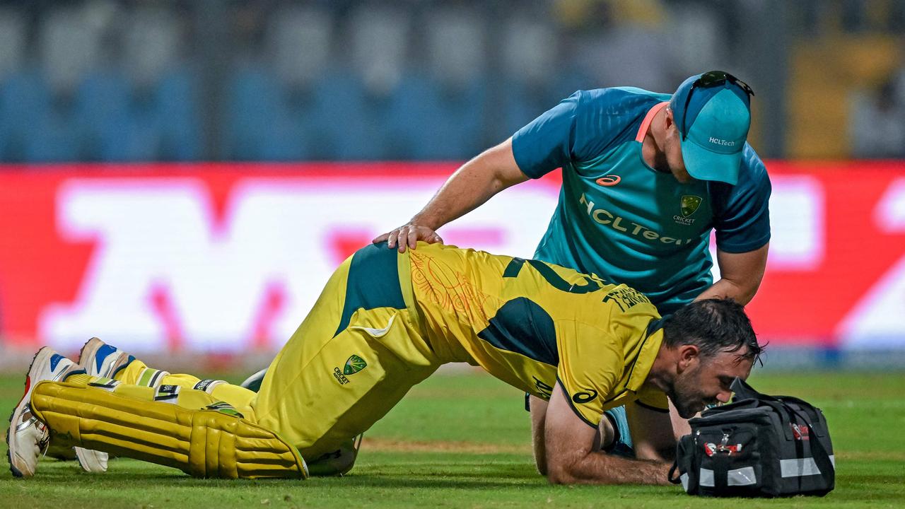 Australia's Glenn Maxwell gets treatment during his phenomenal innings against Afghanistan. (Photo by INDRANIL MUKHERJEE / AFP)