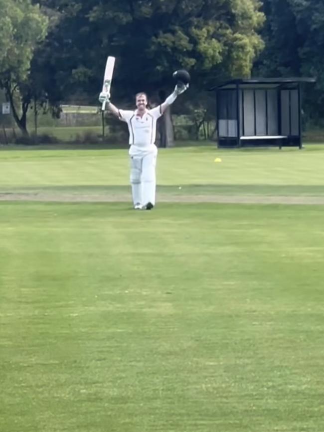 Tom Morris raises his bat after reaching 200.