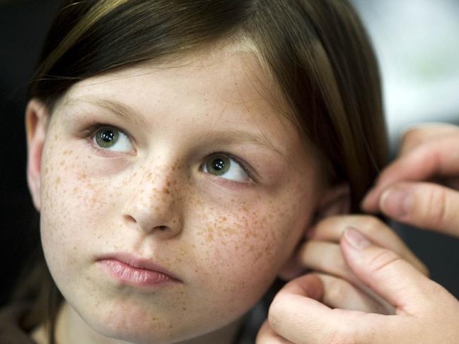 10/05/2010 WIRE: FILE -This May 2010 file photo shows Zahra Clare Baker, 10, getting a hearing aid during an event at Charlotte Motor Speedway in Hickory, N.C. Elisa Baker , stepmother of Zahra Clare Baker, was indicted Monday, Feb. 21, 2011 on a second-degree murder charge in Zahra Clare Baker's death. Elisa Baker had previously been charged with obstructing justice in the investigation of Zahra Baker's death. The 10-year-old was reported missing in October, and police later found her remains in different locations in western North Carolina. (AP Photo/The Independent Tribune, James Nix, File)