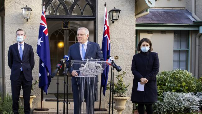 NSW Treasurer Dominic Perrottet, left, Prime Minister Scott Morrison and NSW Premier Gladys Berejiklian, right, announce the Covid rescue package at Kirribilli House in Sydney yesterday. Picture: Getty Images