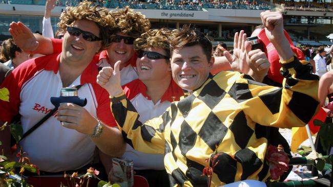 Jockey Craig Williams celebrates with the crowd at Oaks Day.