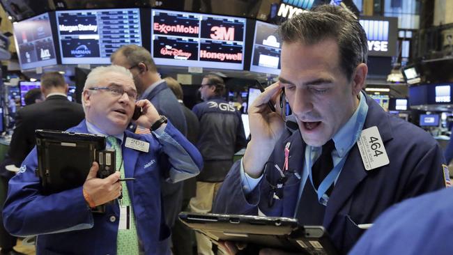 Traders James Dresch, left, and Gregory Rowe work on the floor of the New York Stock Exchange, Monday, Nov. 14, 2016. (AP Photo/Richard Drew)